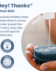 A hand holding The scrub-dub® Scalp and Body Scrubber as soap is dispensed onto it. Text highlights the scrubber's effectiveness and gentleness, accompanied by icons stating that it reduces breakouts and is safe on sensitive skin.