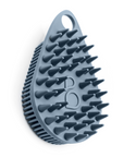 Scrub-dub™ Scalp and Body Scrubber features a teardrop shape and rows of gentle bristles, in a gray color, isolated on a white background.