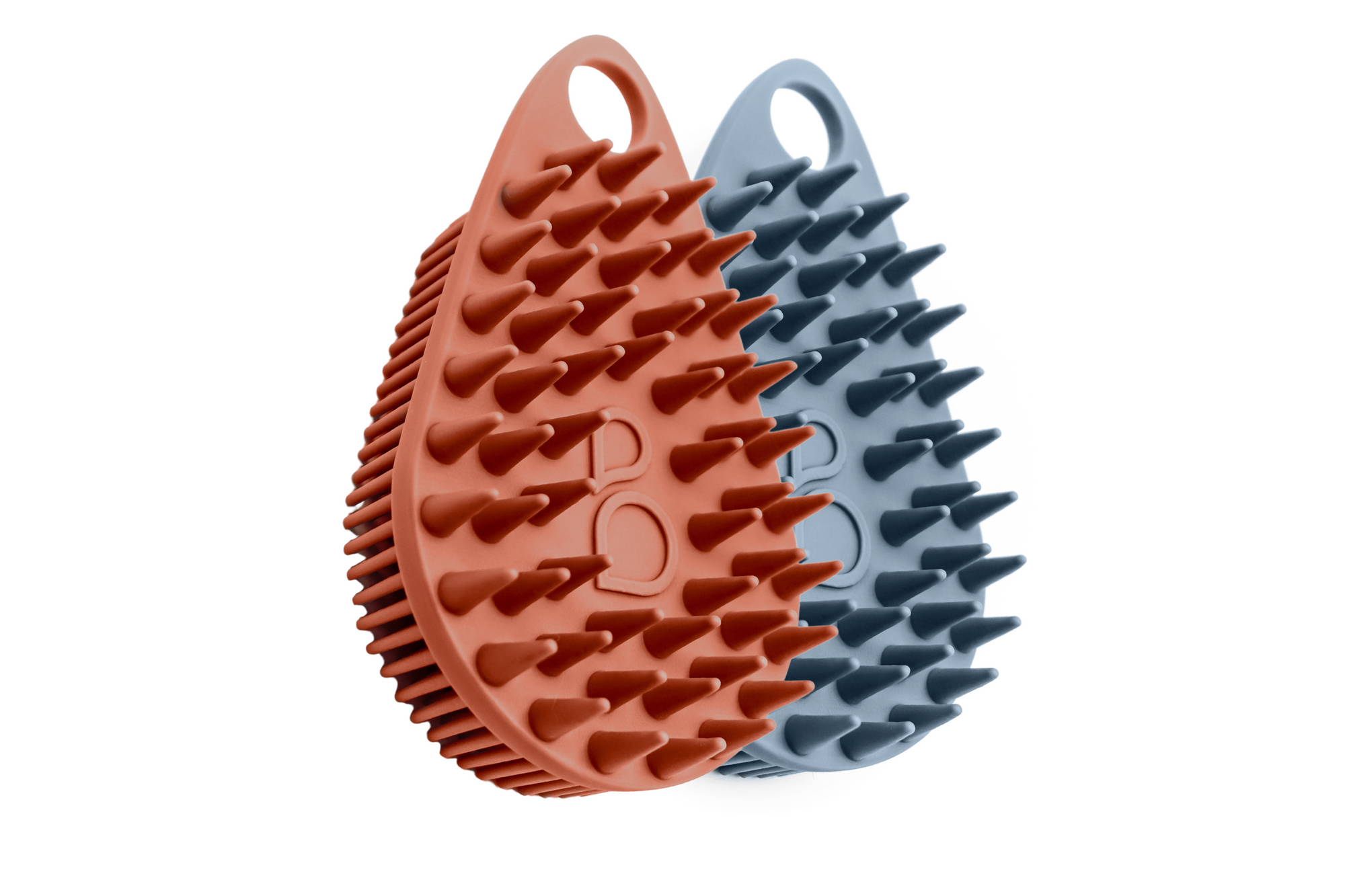 Introducing the Scrub-dub™ Scalp & Body Scrubber Duo Pack: a set of two textured silicone exfoliating scrubbers in terracotta red and slate blue. These antimicrobial body scrubbers feature a convenient hanging hole, ideal for keeping your skin fresh and revitalized no matter where your adventures take you.