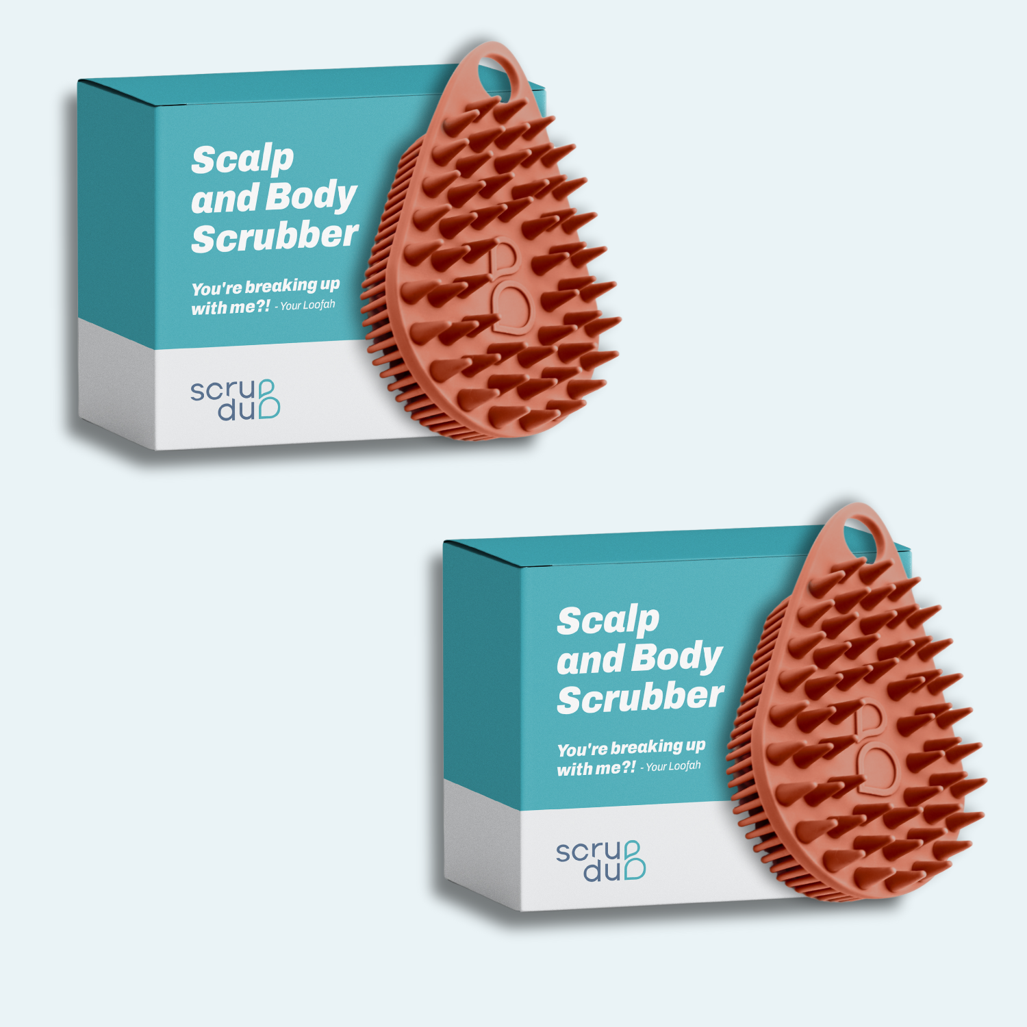 Two *scrub-dub®* Scalp and Body Scrubbers, featuring spiky textures in a vibrant orange hue, are designed to exfoliate the skin smoothly and are showcased with their sleek blue and white packaging.