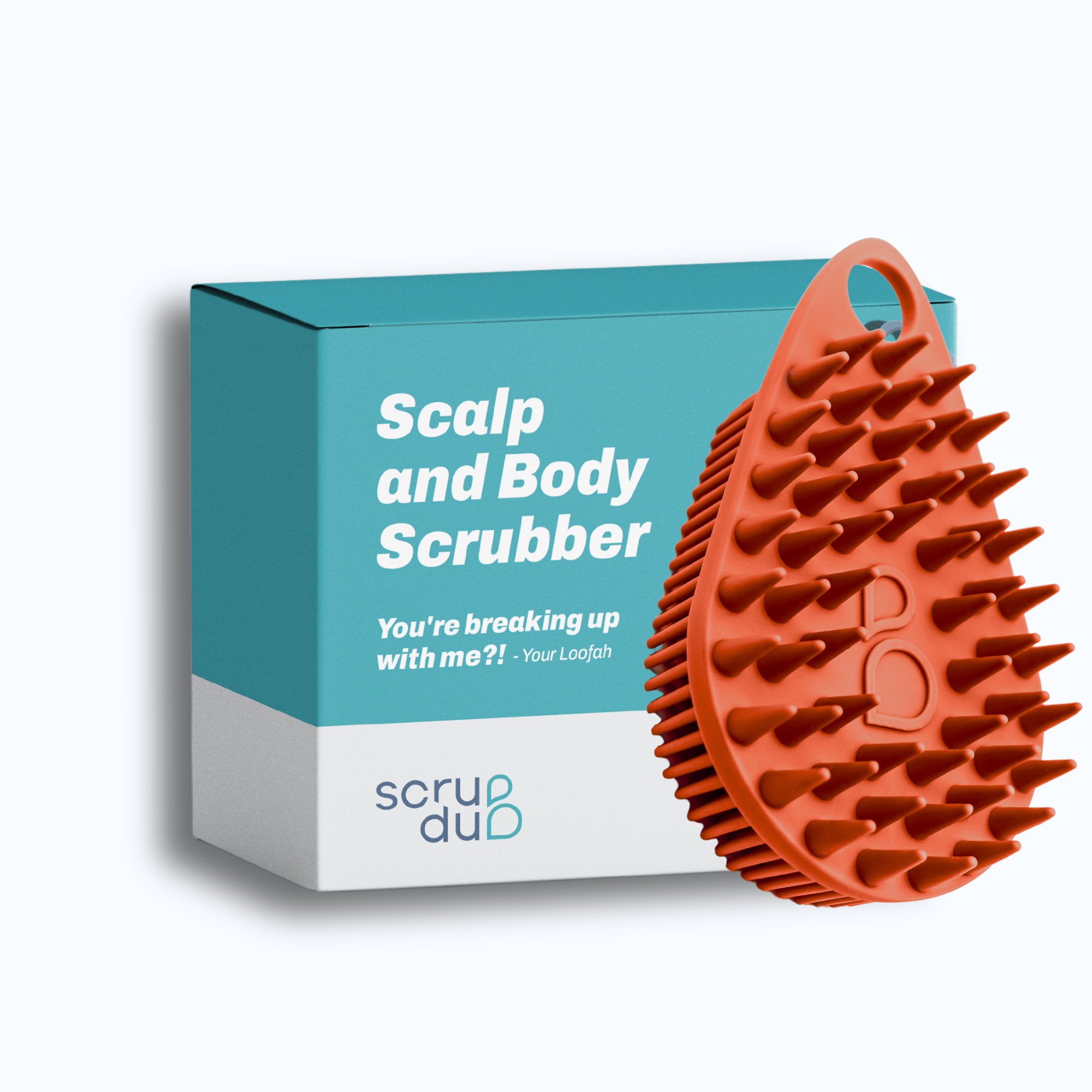 A red exfoliating brush is shown next to its blue and white packaging labeled &quot;The scrub-dub® Scalp and Body Scrubber.&quot; The box also includes the text: &quot;You&#39;re breaking up with me?! - Your Loofah.