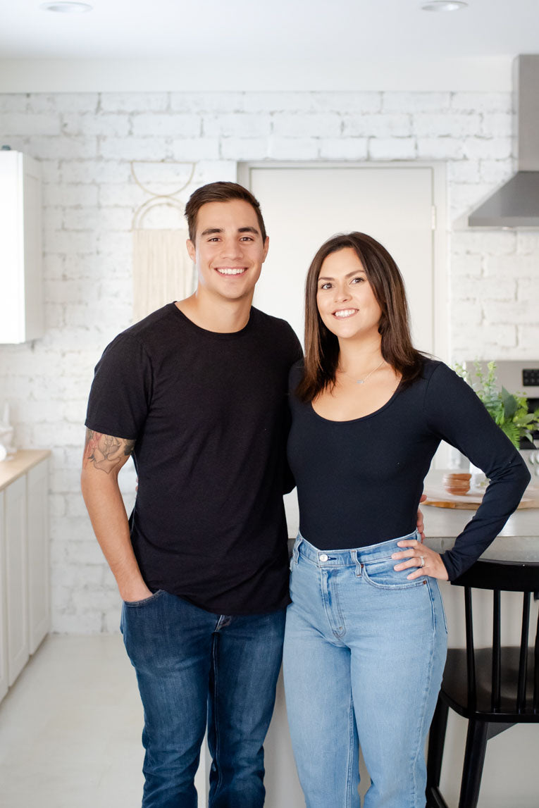 Two Scrub-dub™ founders, one male and one female, pose for photo wearing black shirts and jeans. 